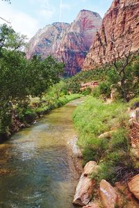 Scenic view of river amidst mountains against sky