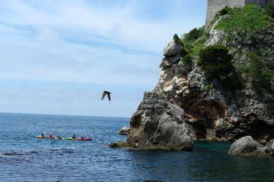 Scenic view of rock formation in sea against sky