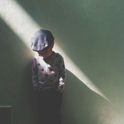 Woman standing against wall