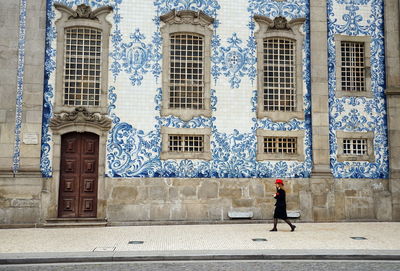 Full length of woman walking outside building