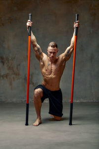 Low angle view of young man exercising in park