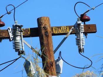 Low angle view of lamp post against clear blue sky