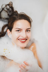 Portrait of smiling young woman in bathroom