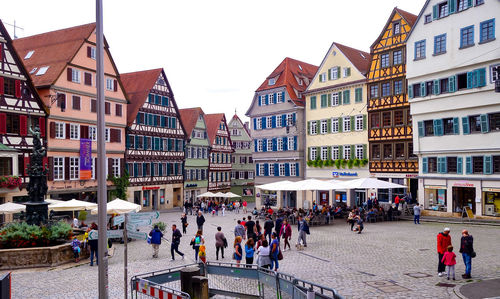 People on street in city against sky