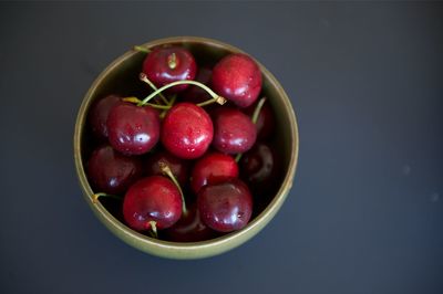 Close-up of strawberries in bowl against black background