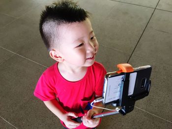 High angle view of girl holding camera