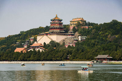 Scenic view of buildings and trees against clear sky