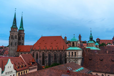 View of buildings in town against sky