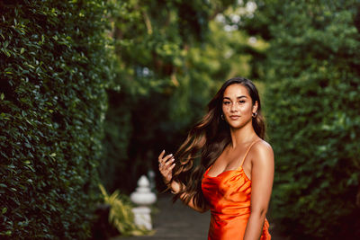 Portrait of beautiful brunette woman with long wavy hair