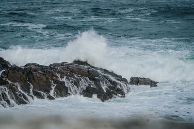 Waves splashing on rocks at shore