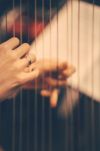 Cropped hands playing string instrument