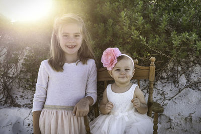 Portrait of smiling sisters outdoors