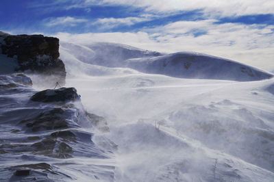 Scenic view of waterfall against sky