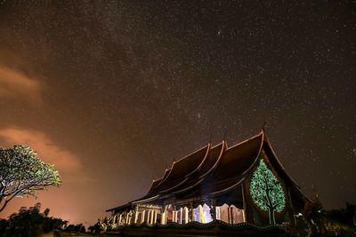 Low angle view of illuminated building against sky at night