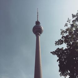 Low angle view of communications tower against sky