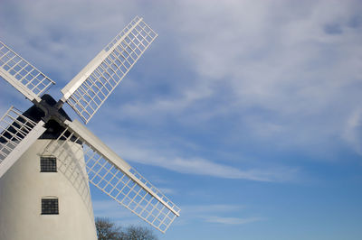 Low angle view of traditional windmill against sky