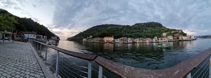 Panoramic view of river by buildings against sky