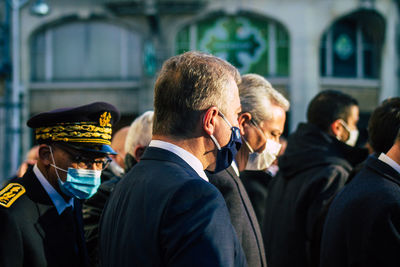 Rear view of people standing outdoors