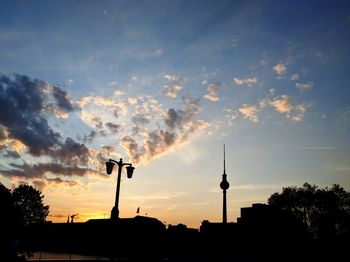 Low angle view of fernsehturm against sky at sunset
