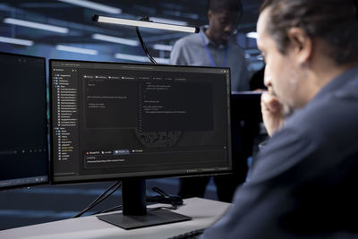 Side view of man working in office