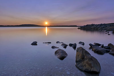 Scenic view of lake against sky during sunset