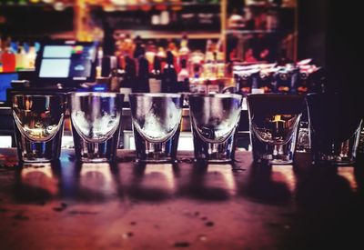 Close-up of empty shot glasses on bar counter