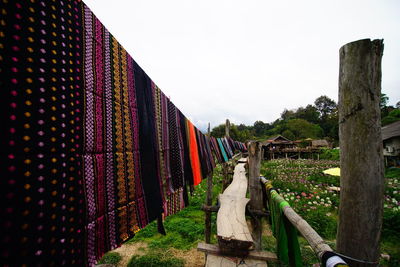 Panoramic shot of multi colored umbrellas hanging against sky