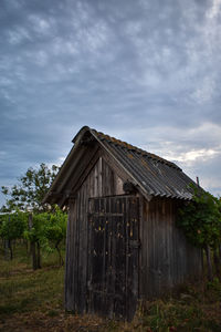 Abandoned building on field against sky