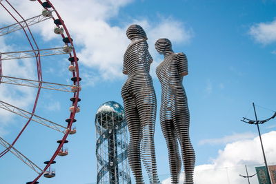 Low angle view of sculpture against cloudy sky