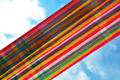 Low angle view of multi colored umbrellas against sky