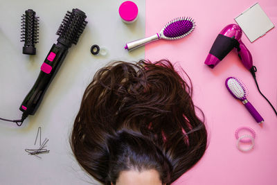 Woman with brown hair by personal accessories on table