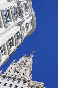 Low angle view of buildings against clear blue sky