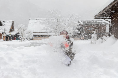 Snow covered buildings in city