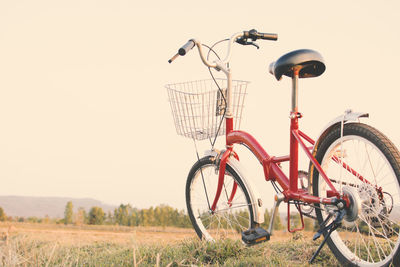 Bicycle parked against clear sky