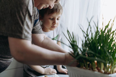 High angle view of woman holding plant