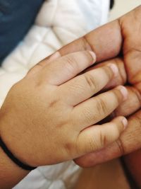 Close-up of hand holding hands