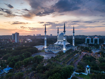 Panoramic view of buildings in city against sky during sunset