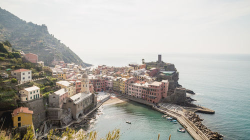 High angle view of cityscape by sea against sky