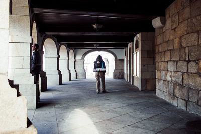 Rear view of man standing on archway