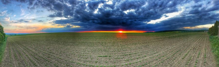 Scenic view of landscape against cloudy sky