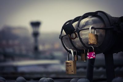 Close-up of love locks on wet street light