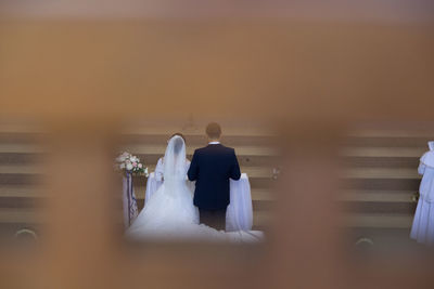 Rear view of bride and groom in church