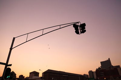 Low angle view of street light against sky at sunset