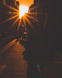 Man on illuminated street at night