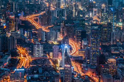 Aerial view of city lit up at night