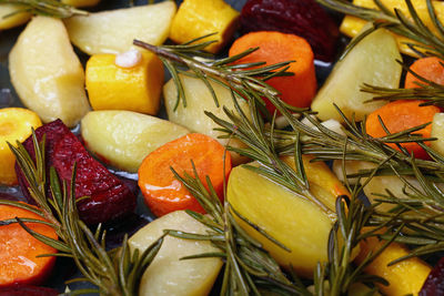 Full frame shot of roasted vegetables with herb in plate