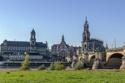 Buildings in city against clear sky