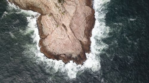 High angle view of rock formations in sea