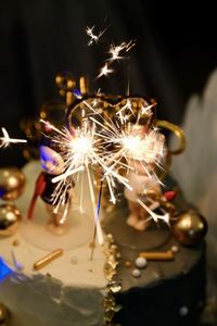 Close-up of sparklers on cake