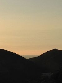 Scenic view of mountains against sky at sunset